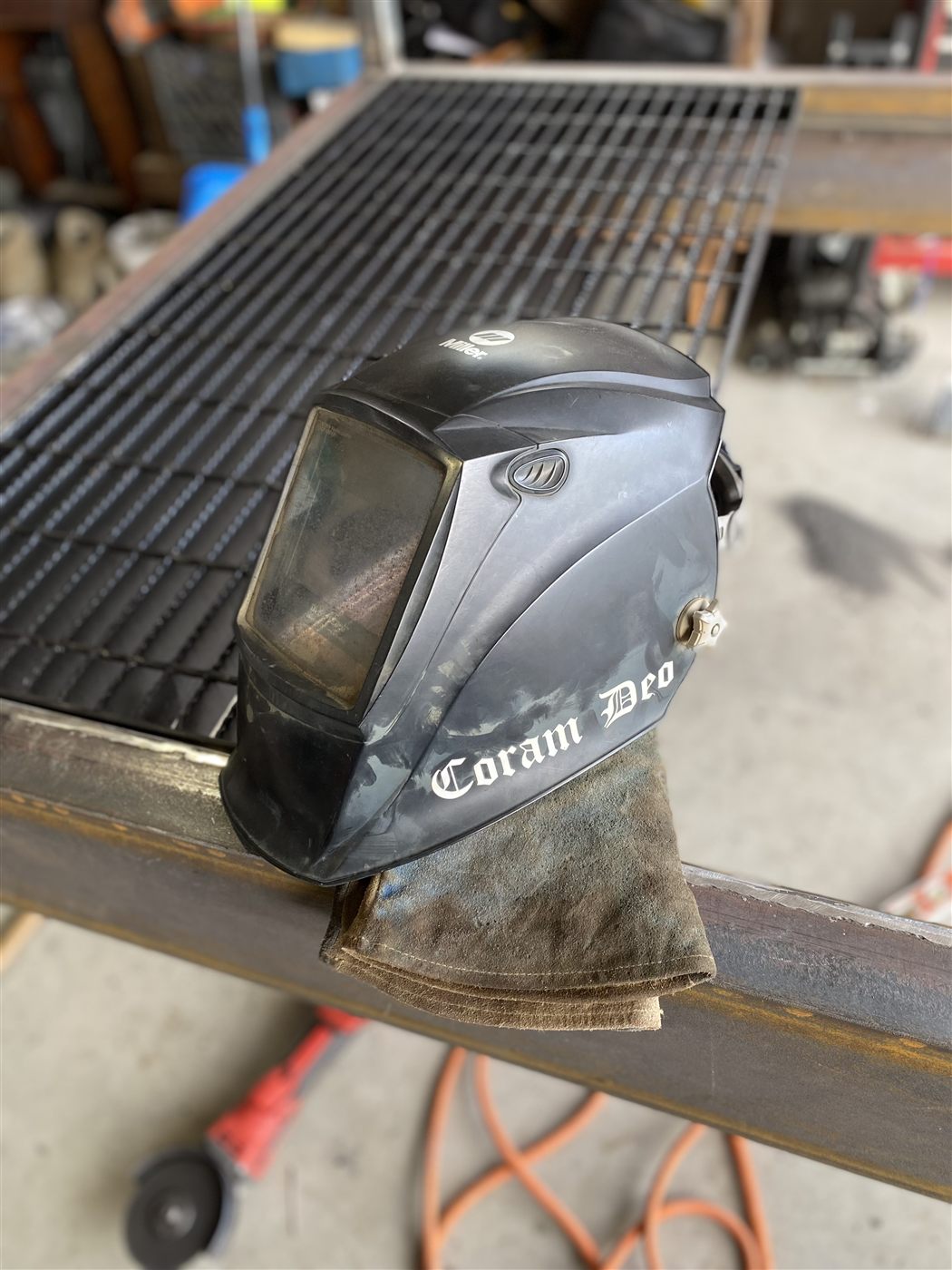 Coram Deo welding helmet on the steel grating